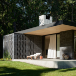 Interior view of The Rambler, showcasing a stylish and contemporary dining space with a warm ambiance. The design features wooden beams, large windows allowing natural light, and a mix of modern and rustic decor. Tables are set for dining, and the space includes a bar area with stylish seating, creating an inviting atmosphere for guests.